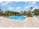 Community swimming pool with lounge chairs, palm trees, and well-maintained surrounding area at 6611 Time Square Ave # 103, Orlando, FL 32835