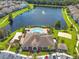 Aerial view showcasing community amenities including a swimming pool, clubhouse, and surrounding lush landscaping at 6636 S Goldenrod Rd # 116B, Orlando, FL 32822