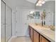 Bright bathroom features double sinks, a full vanity, tiled floor, large mirror, and glass enclosed shower at 6636 S Goldenrod Rd # 116B, Orlando, FL 32822