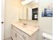 Bright bathroom with marble counter, white cabinets and a matching white toilet at 677 Post Oak Cir # 115, Altamonte Springs, FL 32701