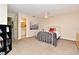 Bright bedroom with neutral walls, plush carpet, and an ensuite bathroom for added convenience and privacy at 677 Post Oak Cir # 115, Altamonte Springs, FL 32701