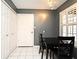 Cozy dining space with white tile floors, a black table set, and natural light from the shuttered window at 677 Post Oak Cir # 115, Altamonte Springs, FL 32701