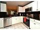 Modern kitchen with stainless steel appliances, white cabinets, and dark countertops, offering style and functionality at 677 Post Oak Cir # 115, Altamonte Springs, FL 32701