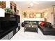 Cozy living room features a black leather sofa, a coffee table, and stylish decor, great for lounging at 677 Post Oak Cir # 115, Altamonte Springs, FL 32701