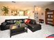 Spacious living room with a black leather sectional sofa, providing ample seating for Gathering and friends at 677 Post Oak Cir # 115, Altamonte Springs, FL 32701