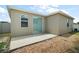 Backyard of house with white fence, small tree, and a cement patio at 7054 Cruz Ct, Lakeland, FL 33813