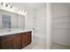 Bathroom featuring double sinks, a large mirror, and a shower over the bathtub, offering ample space at 7054 Cruz Ct, Lakeland, FL 33813