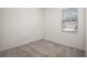 Bright bedroom with a window, neutral walls, and gray carpet at 7054 Cruz Ct, Lakeland, FL 33813