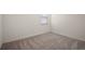 Bright bedroom with a window, neutral walls, and gray carpet at 7054 Cruz Ct, Lakeland, FL 33813