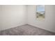 Bright bedroom with a window, neutral walls, and gray carpet at 7054 Cruz Ct, Lakeland, FL 33813
