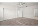 Bright bedroom with carpet, ceiling fan, two doors, and white walls for a simple yet elegant appeal at 7054 Cruz Ct, Lakeland, FL 33813