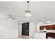 Open living space with modern chandelier and kitchen island, offering a seamless flow for entertaining at 7054 Cruz Ct, Lakeland, FL 33813