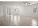 Spacious living room featuring tile flooring, windows, and ceiling fan at 7054 Cruz Ct, Lakeland, FL 33813
