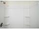 Bathroom showcasing a clean, bright, white shower stall with built-in shelving at 7054 Cruz Ct, Lakeland, FL 33813