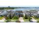 Aerial shot of a home in a lakeside community with manicured lawns at 7500 Alpine Butterfly Ln, Orlando, FL 32819
