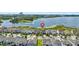Scenic aerial view of a home in a lakeside neighborhood with community amenities at 7500 Alpine Butterfly Ln, Orlando, FL 32819