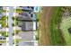 Bird's eye view of a neighborhood showcasing backyard pools and proximity to a lake at 7500 Alpine Butterfly Ln, Orlando, FL 32819