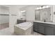 Bathroom with a soaking tub, and gray granite vanity that offers a luxurious bathing experience at 7500 Alpine Butterfly Ln, Orlando, FL 32819