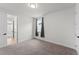 Cozy bedroom with neutral carpeting and a window with sheer curtains at 7500 Alpine Butterfly Ln, Orlando, FL 32819