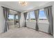 Bright bedroom with sliding glass doors and large windows with view of the lake at 7500 Alpine Butterfly Ln, Orlando, FL 32819