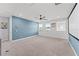Large bonus room with carpet, a blue accent wall, a ceiling fan, and a media screen at 7500 Alpine Butterfly Ln, Orlando, FL 32819