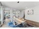 Dining room with wood floors, stairway, and a modern lighting fixture at 7500 Alpine Butterfly Ln, Orlando, FL 32819