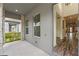 Covered entryway featuring stone columns, neutral wall color, and view to front yard at 7500 Alpine Butterfly Ln, Orlando, FL 32819