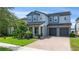 Charming two-story home featuring a manicured front yard and a two-car garage at 7500 Alpine Butterfly Ln, Orlando, FL 32819