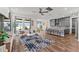 Spacious living room with wood floors, and view to kitchen and water at 7500 Alpine Butterfly Ln, Orlando, FL 32819