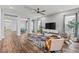 Open concept living room with wood floors, ceiling fan, and modern decor at 7500 Alpine Butterfly Ln, Orlando, FL 32819