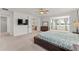 Bright and airy main bedroom featuring an ensuite bathroom and a seating area at 7500 Alpine Butterfly Ln, Orlando, FL 32819