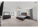 Spacious main bedroom featuring a seating area, neutral decor, and ample natural light at 7500 Alpine Butterfly Ln, Orlando, FL 32819