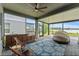 Entertain in style in this screened patio with a built-in kitchen, stylish fan, and stunning lake views at 7500 Alpine Butterfly Ln, Orlando, FL 32819