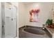 Elegant bathroom featuring a deep soaking tub, glass shower, and tasteful decor, perfect for relaxation at 7628 Bay Port Rd # 43, Orlando, FL 32819