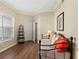 Charming bonus room with hardwood floors, a comfortable daybed, and a view of the neighborhood, a versatile space at 7628 Bay Port Rd # 43, Orlando, FL 32819