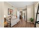 Versatile bonus room with hardwood floors, a daybed, and a view into other living areas, perfect for relaxation at 7628 Bay Port Rd # 43, Orlando, FL 32819