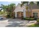 Charming clubhouse entrance with well-maintained landscaping and ample parking space at 7628 Bay Port Rd # 43, Orlando, FL 32819
