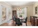 Cozy dining area features a wooden table set, chandelier, and French doors to bring the outside in at 7628 Bay Port Rd # 43, Orlando, FL 32819