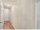 Bright hallway with hardwood floors, leading to various rooms in the home, offering a welcoming atmosphere at 7628 Bay Port Rd # 43, Orlando, FL 32819