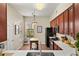 Bright kitchen with cherry cabinets, stainless appliances, and a butcher block island, with a view of the breakfast area at 7628 Bay Port Rd # 43, Orlando, FL 32819