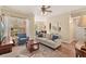 Open concept living room with hardwood floors, a large window and a view into the dining room at 7628 Bay Port Rd # 43, Orlando, FL 32819