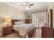 Serene main bedroom with hardwood floors, stylish furniture, and access to the balcony at 7628 Bay Port Rd # 43, Orlando, FL 32819