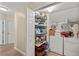Organized pantry with shelving, adjacent to laundry appliances, providing convenient storage and functionality at 7628 Bay Port Rd # 43, Orlando, FL 32819