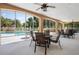 Inviting screened-in pool area with comfortable seating and scenic views of lush greenery at 7628 Bay Port Rd # 43, Orlando, FL 32819