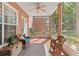 Relaxing screened porch with tile floor, ceiling fan, and comfortable wicker furniture for outdoor living at 7628 Bay Port Rd # 43, Orlando, FL 32819