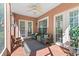 Inviting screened porch features cozy wicker furniture, ceiling fan, and serene outdoor views at 7628 Bay Port Rd # 43, Orlando, FL 32819