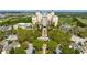 Breathtaking aerial view of a hotel and resort surrounded by lush greenery, golf course and picturesque landscape at 812 Driving Range Ct, Reunion, FL 34747