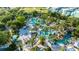 Aerial view of the resort showcasing palm trees, many pools and blue umbrellas for rest and relaxation at 812 Driving Range Ct, Reunion, FL 34747