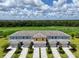 Aerial view of colorful townhomes overlooking the lush green golf course community at 812 Driving Range Ct, Reunion, FL 34747