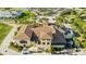 Aerial image of the Reunion Resort clubhouse with palm trees and lush landscaping at 812 Driving Range Ct, Reunion, FL 34747